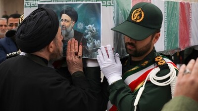 In this photo released by the Iranian Presidency Office, a cleric kisses the flag-draped coffin of President Ebrahim Raisi during a funeral ceremony for him and his companions who were killed in a helicopter crash on Sunday in a mountainous region of the country's northwest, in the city of Tabriz, Iran (AP) In this photo released by the Iranian Presidency Office, a cleric kisses the flag-draped coffin of President Ebrahim Raisi during a funeral ceremony for him and his companions who were killed in a helicopter crash on Sunday in a mountainous region of the country's northwest, in the city of Tabriz, Iran (AP)