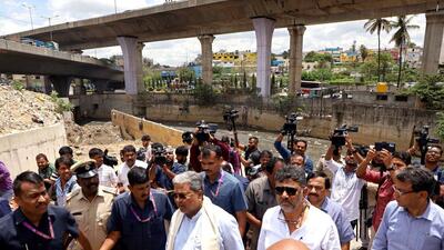 Karnataka CM Siddaramaiah along with deputy CM DK Shivakumar and BBMP officials inspect the preventive measures taken near open drains and low areas ahead of monsoon, in Bengaluru on Wednesday. (ANI) Karnataka CM Siddaramaiah along with deputy CM DK Shivakumar and BBMP officials inspect the preventive measures taken near open drains and low areas ahead of monsoon, in Bengaluru on Wednesday. (ANI)
