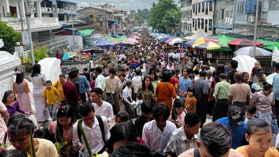 Crowds made their way up a roofed stairway, crowded with stalls offering flowers, candles, and incense, to reach the hilltop complex that towers over the skyline of Yangon's bustling commercial hub. (AFP) Crowds made their way up a roofed stairway, crowded with stalls offering flowers, candles, and incense, to reach the hilltop complex that towers over the skyline of Yangon's bustling commercial hub. (AFP)
