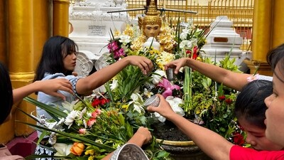 Towering above them was the main, gold-plated spire of the Shwedagon Pagoda, which rises 99 meters (325 feet) into the sky and is believed to house four relics of the Buddha. (AFP) Towering above them was the main, gold-plated spire of the Shwedagon Pagoda, which rises 99 meters (325 feet) into the sky and is believed to house four relics of the Buddha. (AFP)