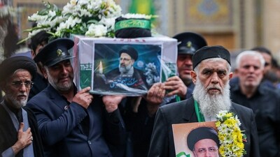 A member of a honour guards weeps while carrying the coffin of Iran's President Ebrahim Raisi during a funeral procession in Qom. (AFP)