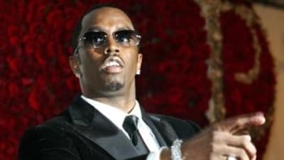 This November 4, 2004, file photo shows Sean ‘P. Diddy’ Combs directing photographers as they sing "Happy Birthday," to him as his date Kim Porter, left, listens, after Combs arrived for his 35th birthday celebration at Cipriani on Wall Street in New York. (AP)