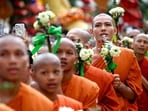 Buddhist monks hold lotus flowers as they pray during the Visak Bochea Buddhist celebration at a pagoda in Phnom Penh.&nbsp;(AFP)