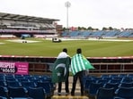 Fans, draped in Pakistan flags, watch as groundstaff attempt to clear rain water from the pitch ahead of the first T20I vs England Fans, draped in Pakistan flags, watch as groundstaff attempt to clear rain water from the pitch ahead of the first T20I vs England