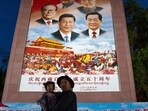 Chat Xi PT: A man holds a girl as they pose for a photo in front of a large mural depicting Chinese President Xi Jinping, bottom center, and other Chinese leaders at a public square at the base of the Potala Palace. Chat Xi PT: A man holds a girl as they pose for a photo in front of a large mural depicting Chinese President Xi Jinping, bottom center, and other Chinese leaders at a public square at the base of the Potala Palace.