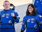 Spacecraft commander Barry Wilmore (L) and pilot Suni Williams walkout from the Neil A. Armstrong operations and checkout building at NASA's Kennedy Space Center in Cape Canaveral, Florida.(AFP)