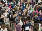 Travellers move through a security checkpoint in Denver International Airport ahead of the Memorial Day holiday, in Denver. A record number of Americans are expected to hit the pavement and the air over the 2024 Memorial Day weekend. 