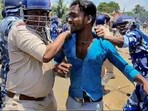 Purba Medinipur: Security personnel detain an agitator during a protest of BJP over the killing of a woman BJP worker, at Nandigram. (PTI)