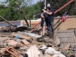 Phillip and Kimberly Ergish embrace as they look at the remnants of their home the day after a deadly tornado struck Greenfield, Iowa, U.S. May 22, 2024. Kimberly survived the storm in their basement with their four children aged 5 to 12 and their dog while Phillip was at work. No one was injured. REUTERS/Scott Morgan