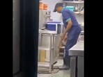 The man was seen cleaning the drain with frying net. 
