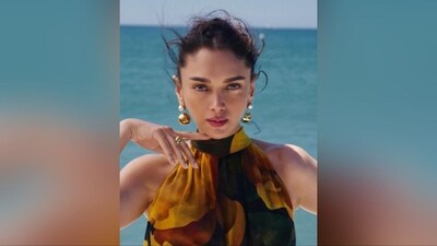 In terms of accessories, she styled her look with a pair of golden drop statement earrings from Litmus India, quirky gold rings adorning her fingers, and a pair of stylish black high heels, perfectly complementing her ravishing look. (Instagram/@aditiraohydari)