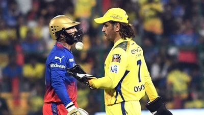 Chennai Super Kings' MS Dhoni and Royal Challengers Bengaluru's Dinesh Karthik during a match. (ANI)