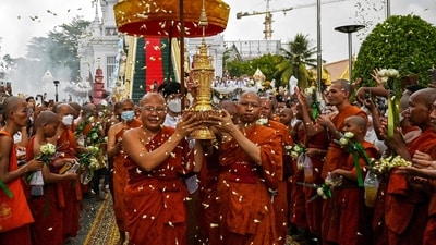 Cambodian Buddhist monks carry an urn which allegedly contains the remains of one of Buddha's bone inside during the Visak Bochea Buddhist celebration at a pagoda in Phnom Penh. (AFP)