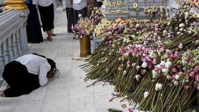 A woman prays at the Buddha stupa during the Visak Bochea Buddhist celebration at a pagoda in Phnom Penh. (AFP)