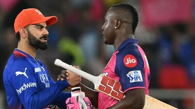 Royal Challengers Bengaluru's Virat Kohli (L) greets Rajasthan Royals' Rovman Powell (C) after their win. (AFP) Royal Challengers Bengaluru's Virat Kohli (L) greets Rajasthan Royals' Rovman Powell (C) after their win. (AFP)