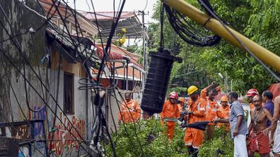 Firemen remove fallen trees after rainfall, in Thiruvananthapuram, Thursday. (PTI) Firemen remove fallen trees after rainfall, in Thiruvananthapuram, Thursday. (PTI)