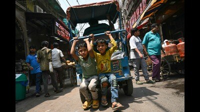 For Representation: Boys ride a rickshaw on a hot summer day in the old quarters of New Delhi on May 22 (Arun SANKAR / AFP)
