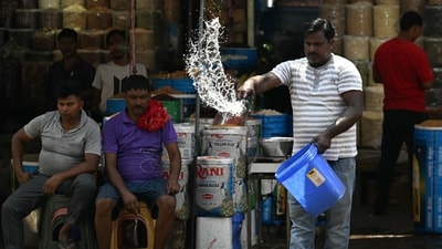 A man sprinkles water in front of his shop during a hot summer day in the old quarters of New Delhi. (AFP) A man sprinkles water in front of his shop during a hot summer day in the old quarters of New Delhi. (AFP)