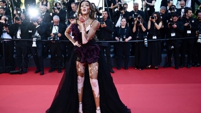 Winnie Harlow exuded sophistication and sleekness on the "Le Comte De Monte-Cristo" red carpet at the 77th annual Cannes Film Festival. She stunned in Zuhair Murad Couture, boasting an oversized floral embellishment and a dramatic train at the back, elegantly showcasing her legs. Her look was perfectly complemented with diamond jewelry, adding a touch of luxury to her ensemble. (Christophe SIMON/AFP) Winnie Harlow exuded sophistication and sleekness on the "Le Comte De Monte-Cristo" red carpet at the 77th annual Cannes Film Festival. She stunned in Zuhair Murad Couture, boasting an oversized floral embellishment and a dramatic train at the back, elegantly showcasing her legs. Her look was perfectly complemented with diamond jewelry, adding a touch of luxury to her ensemble. (Christophe SIMON/AFP)