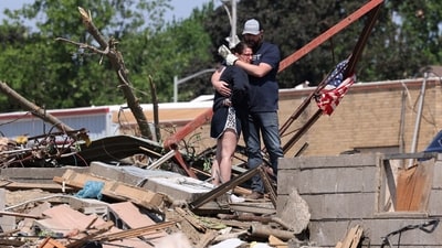 Phillip and Kimberly Ergish embrace as they look at the remnants of their home the day after a deadly tornado struck Greenfield, Iowa, U.S. May 22, 2024. Kimberly survived the storm in their basement with their four children aged 5 to 12 and their dog while Phillip was at work. No one was injured. REUTERS/Scott Morgan (REUTERS)