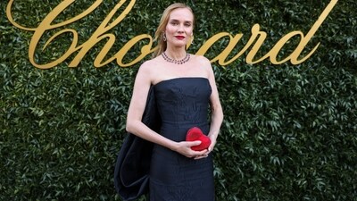 Diane Kruger wears Emilia Wickstead to the Chopard 'Once Upon a Time' dinner at Cannes 2024. Her stunning black gown features an off-the-shoulder neckline, a fitted silhouette and intricate floral detailing. Styled with a small red heart clutch, diamond necklace and matching earrings, she looked both stylish and elegant. (Vianney Le Caer/Invision/AP) Diane Kruger wears Emilia Wickstead to the Chopard 'Once Upon a Time' dinner at Cannes 2024. Her stunning black gown features an off-the-shoulder neckline, a fitted silhouette and intricate floral detailing. Styled with a small red heart clutch, diamond necklace and matching earrings, she looked both stylish and elegant. (Vianney Le Caer/Invision/AP)