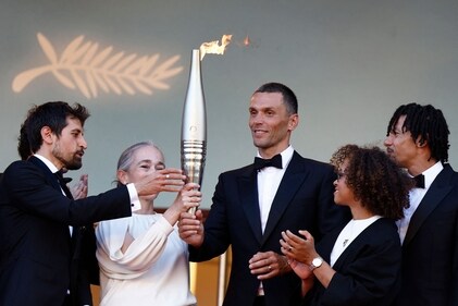French para athlete Alexis Hanquinquant holds the Olympic Torch before the screening of the film "Marcello Mio" at the 77th edition of the Cannes Film Festival in Cannes. (AFP) French para athlete Alexis Hanquinquant holds the Olympic Torch before the screening of the film "Marcello Mio" at the 77th edition of the Cannes Film Festival in Cannes. (AFP)