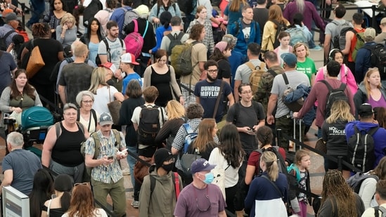 Travellers move through a security checkpoint in Denver International Airport ahead of the Memorial Day holiday, in Denver. A record number of Americans are expected to hit the pavement and the air over the 2024 Memorial Day weekend. (AP Photo/David Zalubowski, File)