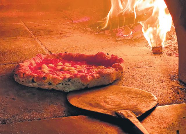 In Naples, pizzas are baked in a hot oven for just one minute at a temperature of around 500° c. (SHUTTERSTOCK) In Naples, pizzas are baked in a hot oven for just one minute at a temperature of around 500° c. (SHUTTERSTOCK)