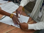 A woman offers her thumb impression before voting (PTI) A woman offers her thumb impression before voting (PTI)