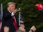 Republican presidential candidate former President Donald Trump throws a "MAGA" hat during a campaign rally in the south Bronx, Thursday, May. 23, 2024, in New York. (AP Photo/Yuki Iwamura)