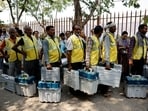 People carry Voter Verifiable Paper Audit Trail (VVPAT) and Electronic Voting Machines (EVM) at a distribution centre ahead of the sixth phase of India's general election in New Delhi, India, May 24, 2024. REUTERS/Anushree Fadnavis
