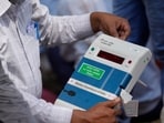 Uttar Pradesh Lok Sabha Election Phase 6: A polling official checks an Electronic Voting Machines (EVMs) before transporting it to his polling station.