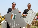 Polling officials leave for their respective polling booths after collecting EVMs and other election materials from a distribution centre on the eve of the sixth phase of Lok Sabha polls, in Gurugram on Friday. (ANI)