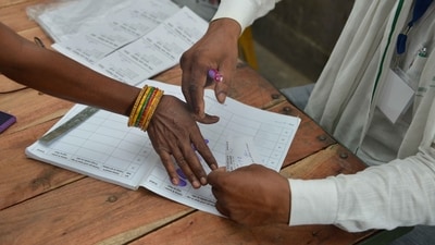 A woman offers her thumb impression before voting (PTI) (PTI)