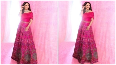 Her outfit is from the shelves of JADE by Monica and Karishma and comes in a captivating fuchsia pink. It features an off-the-shoulder organza blouse paired with a lehenga skirt adorned with intricate Ek Taar artistry with detailed embroidery in multicolours embracing rich craftsmanship. (Instagram/@madhuridixitnene) Her outfit is from the shelves of JADE by Monica and Karishma and comes in a captivating fuchsia pink. It features an off-the-shoulder organza blouse paired with a lehenga skirt adorned with intricate Ek Taar artistry with detailed embroidery in multicolours embracing rich craftsmanship. (Instagram/@madhuridixitnene)