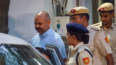 Delhi Police personnel with Chief Minister Arvind Kejriwal's aide Bibhav Kumar (PTI) Delhi Police personnel with Chief Minister Arvind Kejriwal's aide Bibhav Kumar (PTI)
