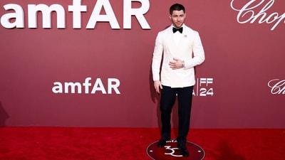 Nick Jonas exuded sophistication on the red carpet in a sharp ensemble consisting of a white blazer paired with black pants. Complementing his attire, he wore a black bow tie, adorned his blazer with a brooch, and completed his look with a pair of shiny black shoes. (Photo by Sameer Al-Doumy / AFP) Nick Jonas exuded sophistication on the red carpet in a sharp ensemble consisting of a white blazer paired with black pants. Complementing his attire, he wore a black bow tie, adorned his blazer with a brooch, and completed his look with a pair of shiny black shoes. (Photo by Sameer Al-Doumy / AFP)