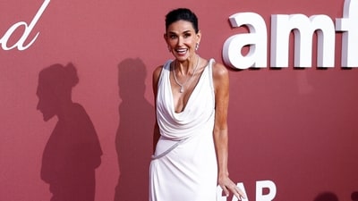 American actress Demi Moore emanates elegance as she graces the annual amfAR Cinema Against AIDS Cannes Gala in an exquisite all-white ensemble. The attire, sourced from the renowned brand Loewe, showcases a deep plunging neckline and a striking thigh-high slit, Adorned with a luxurious diamond necklace and complementing statement earrings, she exudes unmatched glamour and sophistication. (Photo by Sameer Al-Doumy / AFP) American actress Demi Moore emanates elegance as she graces the annual amfAR Cinema Against AIDS Cannes Gala in an exquisite all-white ensemble. The attire, sourced from the renowned brand Loewe, showcases a deep plunging neckline and a striking thigh-high slit, Adorned with a luxurious diamond necklace and complementing statement earrings, she exudes unmatched glamour and sophistication. (Photo by Sameer Al-Doumy / AFP)