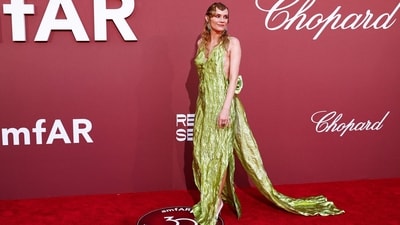 German actress Diane Kruger stunned in a radiant chartreuse gown with a long train and a bow on the back. Her striking green attire featured a plunging neckline and a side slit, exuding drama and sartorial flair. She completed her chic red carpet look with an eye-catching wet hair style and dangling silver earrings. (Photo by Sameer Al-Doumy / AFP) German actress Diane Kruger stunned in a radiant chartreuse gown with a long train and a bow on the back. Her striking green attire featured a plunging neckline and a side slit, exuding drama and sartorial flair. She completed her chic red carpet look with an eye-catching wet hair style and dangling silver earrings. (Photo by Sameer Al-Doumy / AFP)