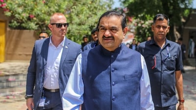 Gautam Adani, chairman of Adani Group, center, arrives at a polling station during the third phase of voting for national elections in Ahmedabad, Gujarat, (Bloomberg) Gautam Adani, chairman of Adani Group, center, arrives at a polling station during the third phase of voting for national elections in Ahmedabad, Gujarat, (Bloomberg)
