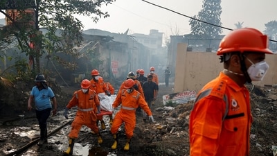 National Disaster Response Force (NDRF) officials carry a dead body on a stretcher at the site of a blast at a chemical factory in Dombivli, on the outskirts of Mumbai on Friday. (REUTERS)