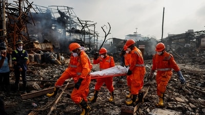 National Disaster Response Force (NDRF) officials carry a dead body on a stretcher at the site of a blast at a chemical factory in Dombivli, on the outskirts of Mumbai, India (REUTERS)