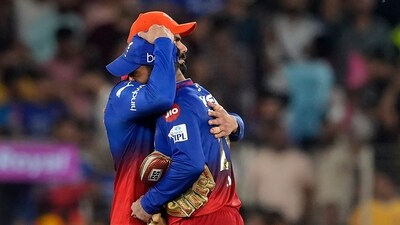 Virat Kohli hugs Dinesh Karthik. (PTI) Virat Kohli hugs Dinesh Karthik. (PTI)