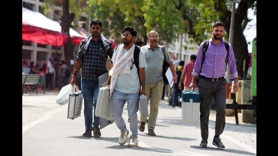 Polling officers carrying Electronic Voting Machines (EVM) and Voter Verifiable Paper Audit Trail (VVPAT) machines walk to a bus to be taken to polling stations ahead of the sixth phase of the Lok Sabha election 2024 in Gurugram on Friday. (Parveen Kumar/HT PHOTO) Polling officers carrying Electronic Voting Machines (EVM) and Voter Verifiable Paper Audit Trail (VVPAT) machines walk to a bus to be taken to polling stations ahead of the sixth phase of the Lok Sabha election 2024 in Gurugram on Friday. (Parveen Kumar/HT PHOTO)