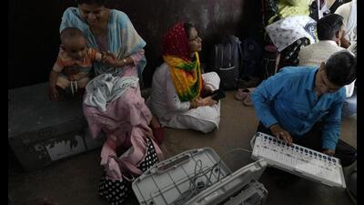 Polling officers check electric voting machines before proceeding to their respective polling stations on the eve of the sixth phase of multi phase general election, in Prayagraj, on Friday. (AP Photo) Polling officers check electric voting machines before proceeding to their respective polling stations on the eve of the sixth phase of multi phase general election, in Prayagraj, on Friday. (AP Photo)