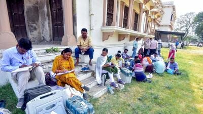Polling officials collect the electronic voting machines and other election materials on the eve of the sixth phase of the Lok Sabha polls, in Prayagraj on Friday. (ANI)