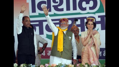 Prime Minister Narendra Modi waves to the supporters during a public meeting supporting BJP candidate from Mandi seat Kangana Ranaut for the Lok Sabha elections, in Mandi on Friday. (Birbal Sharma/HT) Prime Minister Narendra Modi waves to the supporters during a public meeting supporting BJP candidate from Mandi seat Kangana Ranaut for the Lok Sabha elections, in Mandi on Friday. (Birbal Sharma/HT)