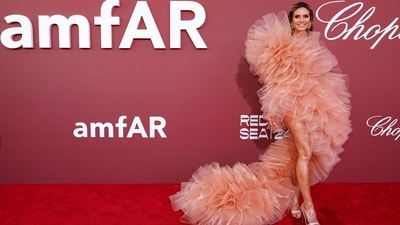German supermodel Heidi Klum made a grand entrance at the yearly amfAR Cinema Against AIDS Cannes Gala, adorned in a striking pastel ruffles gown. Her ensemble featured a ruffled pink tulle dress by Lever Couture, boasting an asymmetrical silhouette and a flowing train. Completing her look with coordinating pumps and oversized silver and green earrings, Klum exuded elegance and style. (Photo by Sameer Al-Doumy / AFP) German supermodel Heidi Klum made a grand entrance at the yearly amfAR Cinema Against AIDS Cannes Gala, adorned in a striking pastel ruffles gown. Her ensemble featured a ruffled pink tulle dress by Lever Couture, boasting an asymmetrical silhouette and a flowing train. Completing her look with coordinating pumps and oversized silver and green earrings, Klum exuded elegance and style. (Photo by Sameer Al-Doumy / AFP)