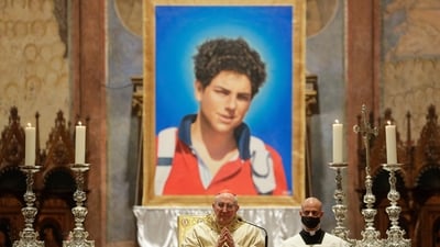 FILE - An image of 15-year-old Carlo Acutis, an Italian boy who died in 2006 of leukemia, is seen during his beatification ceremony celebrated by Cardinal Agostino Vallini, center, in the St. Francis Basilica, in Assisi, Italy, on Oct. 10, 2020. Pope Francis has paved the way for the canonization of the first saint of the millennial generation on Thursday, attributing a second miracle to a 15-year-old Italian computer whiz who died of leukemia in 2006. Carlo Acutis, born on May 3, 1991, in London and then moved with his Italian parents to Milan as a child, was the youngest contemporary person to be beatified by Francis in Assisi in 2020. (AP Photo/Gregorio Borgia, File) (AP) FILE - An image of 15-year-old Carlo Acutis, an Italian boy who died in 2006 of leukemia, is seen during his beatification ceremony celebrated by Cardinal Agostino Vallini, center, in the St. Francis Basilica, in Assisi, Italy, on Oct. 10, 2020. Pope Francis has paved the way for the canonization of the first saint of the millennial generation on Thursday, attributing a second miracle to a 15-year-old Italian computer whiz who died of leukemia in 2006. Carlo Acutis, born on May 3, 1991, in London and then moved with his Italian parents to Milan as a child, was the youngest contemporary person to be beatified by Francis in Assisi in 2020. (AP Photo/Gregorio Borgia, File) (AP)