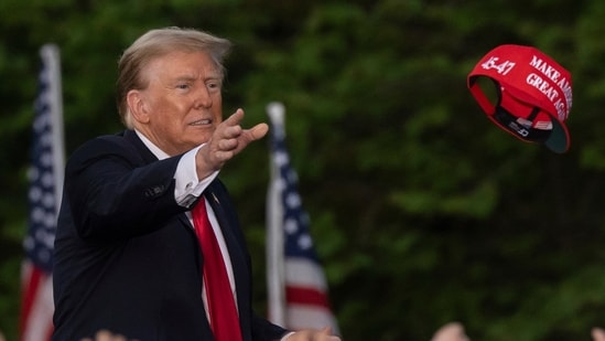 Republican presidential candidate former President Donald Trump throws a "MAGA" hat during a campaign rally in the south Bronx, Thursday, May. 23, 2024, in New York. (AP Photo/Yuki Iwamura) (AP)